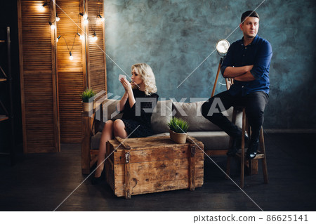 elegant couple posing ay gray decorated studio. elegant couple posing ay gray decorated studio. 86625141