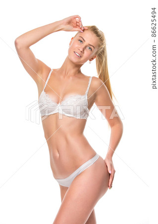 Young blonde woman in white underwear, studio Young blonde woman in white underwear, studio 86625494