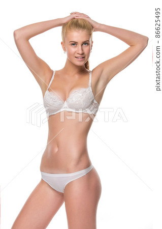 Young blonde woman in white underwear, studio Young blonde woman in white underwear, studio 86625495
