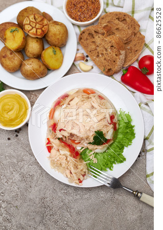 Delicious chicken aspic on a plate on concrete table Delicious chicken aspic on a plate on concrete table 86625528