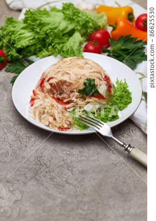 Delicious chicken aspic on a plate on concrete table Delicious chicken aspic on a plate on concrete table 86625530