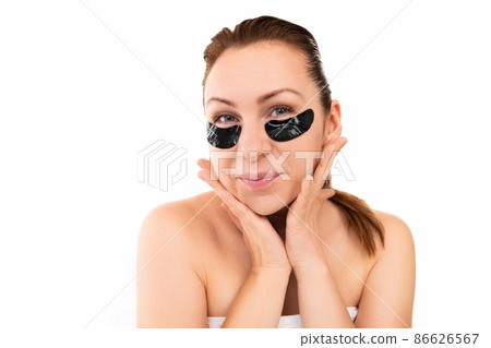 young woman takes care of her skin on a white isolated background 86626567