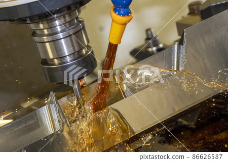 The CNC milling machine cutting the  mold parts with oil coolant method. 86626587