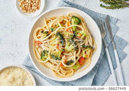 Spaghetti pasta with broccoli, bucatini with peppers, garlic, pine nuts. Food for vegans Spaghetti pasta with broccoli, bucatini with peppers, garlic, pine nuts. Food for vegans 86627449