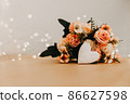 wooden table with a bouquet of flowers and a white heart 86627598