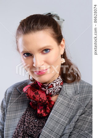 Closeup portrait of young adult woman with healthy skin on grey background 86628074