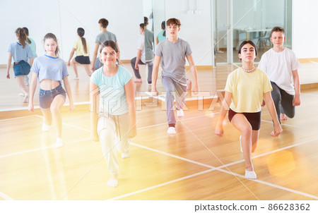 Teenage dancers practicing new dance in studio Teenage dancers practicing new dance in studio 86628362