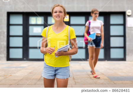 Two young girls going home after school Two young girls going home after school 86628481