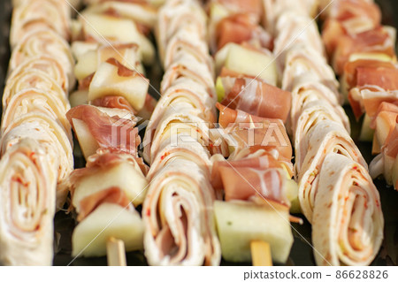 Pork skewers with bacon on white background Pork skewers with bacon on white background 86628826