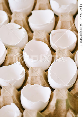 Cracked egg shells in a carton container. Close up. Cracked egg shells in a carton container. Close up. 86629613