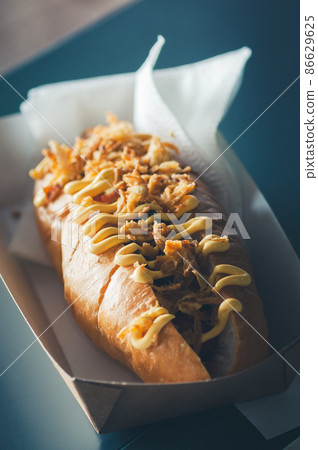 Freshly prepared hotdogs in a paper box. Food delivery concept. 86629625