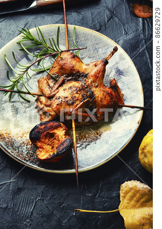 Quail barbecue with quince 86629729