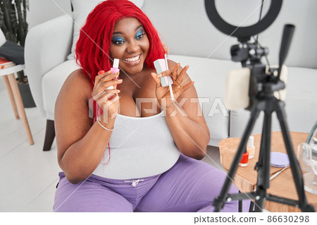 Woman blogger is showing manicure tools in front of the camera of her smartphone Woman blogger is showing manicure tools in front of the camera of her smartphone 86630298