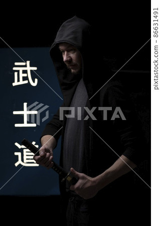 Handsome portrait of a man with katana Japanese sword. 86631491