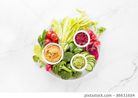Fresh green veggie charcuterie platter with various dips Fresh green veggie charcuterie platter with various dips 86631684