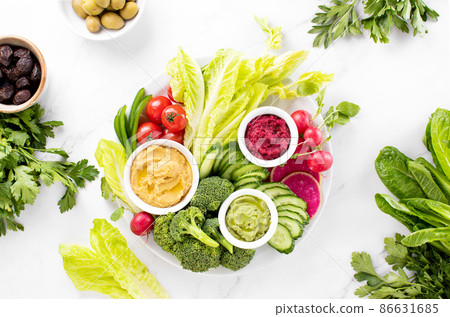 Fresh green veggie charcuterie platter with various dips Fresh green veggie charcuterie platter with various dips 86631685