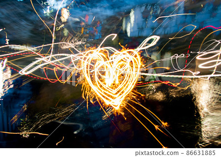 Heart drawn with handheld fireworks Heart drawn with handheld fireworks 86631885
