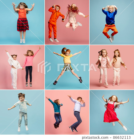 Group of elementary school kids or pupils jumping in colorful casual clothes on blue and pink studio background. Creative collage. 86632113
