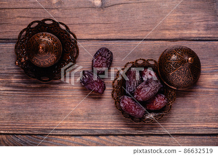 Dried dates fruit and coffee. Popular fruit of Ramadan. Dried dates fruit and coffee. Popular fruit of Ramadan. 86632519
