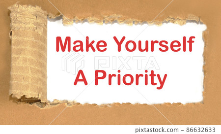 Make Yourself A Priority the inscription appearing behind the torn cardboard paper 86632633