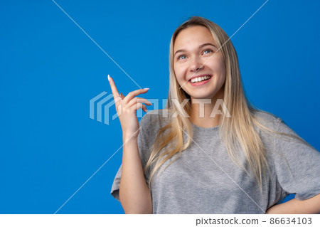 Portrait of pretty teen girl thinking and creating solution against blue background Portrait of pretty teen girl thinking and creating solution against blue background 86634103