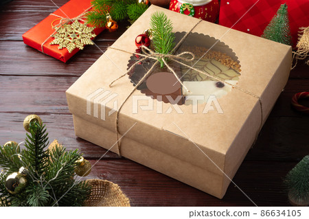 Set of different cakes in a craft box on brown wooden background Set of different cakes in a craft box on brown wooden background 86634105