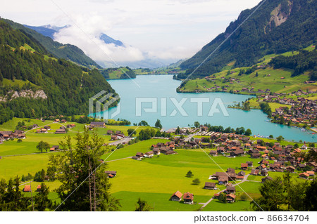 Lake, mountains and village. Aerial view on village in Austria Lake, mountains and village. Aerial view on village in Austria 86634704