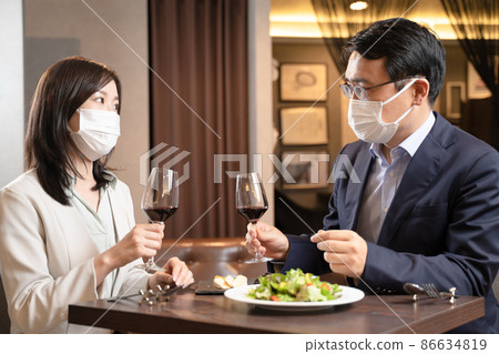 男人和女人在餐廳吃麵具晚餐 86634819