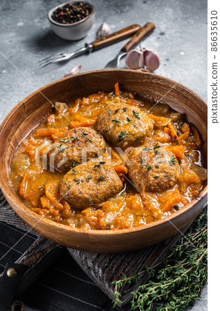 Cutlets or Fish balls with tuna in tomato sauce. Gray background. Top view 86635610
