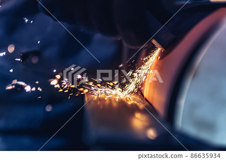Closeup of Sparks that fly out when grinding metal details machine. Metallurgical Plant 86635934
