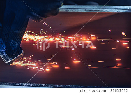 Closeup of Sparks that fly out when grinding metal details machine. Metallurgical Plant 86635962