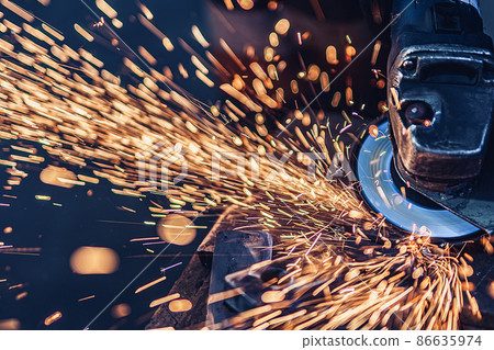 Electric wheel grinding on metal details in factory. Metallurgical Plant  86635974