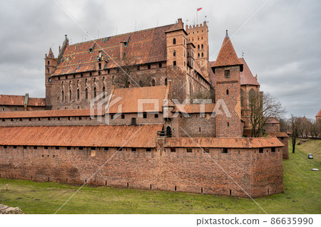 The Castle of the Teutonic Order in Malbork in the Pomerania region, Poland. This is the largest castle in the world measured by land area and a UNESCO World Heritage Site The Castle of the Teutonic Order in Malbork in the Pomerania region, Poland. This is the largest castle in the world measured by land area and a UNESCO World Heritage Site 86635990