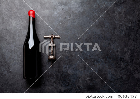 Red wine bottle and vintage corkscrew Red wine bottle and vintage corkscrew 86636458