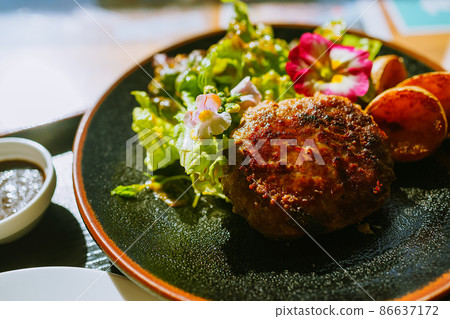 A hamburger steak with flowers is up A hamburger steak with flowers is up 86637172