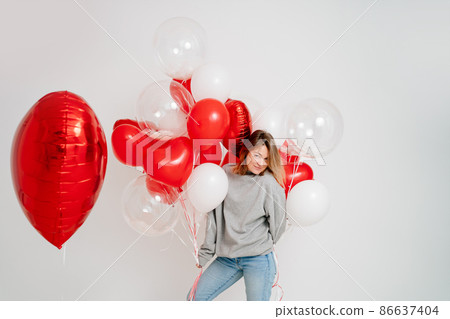 an blonde woman with balloons on a white background.  86637404