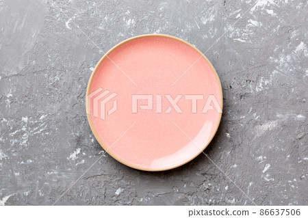 Top view of empty pink plate on cement background. Empty space for your design Top view of empty pink plate on cement background. Empty space for your design 86637506