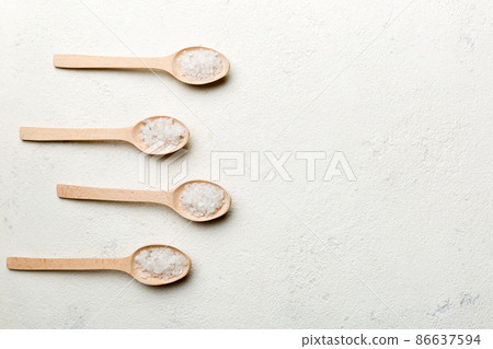 salt on many wooden spoon on wood background. Spoons with different salt salt on many wooden spoon on wood background. Spoons with different salt 86637594