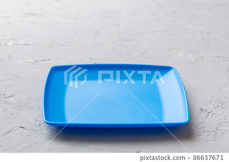 Perspective view of empty square plate on cement background. Empty space for your design Perspective view of empty square plate on cement background. Empty space for your design 86637671