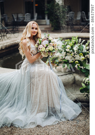 Elegant sensual blondy bride holding flowers and Elegant sensual blondy bride holding flowers and 86637997