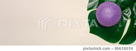 Banner. Natural, organic and konjac sponge on a tropical leaf. Sustainable concept. Copy space 86638039