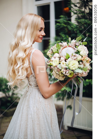 Bride in perfect wedding dress posing against 86638056