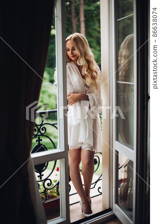 Gorgeous blondie bride walking at balcony and Gorgeous blondie bride walking at balcony and 86638074