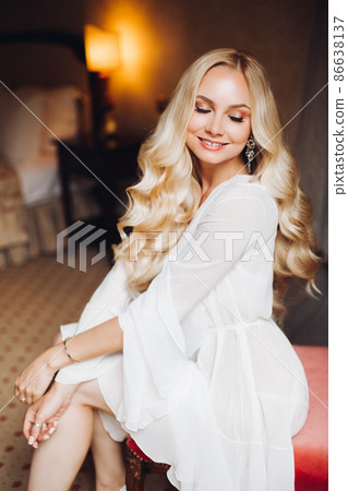 Beautiful blondie bride in bedroom, dreaming with Beautiful blondie bride in bedroom, dreaming with 86638137