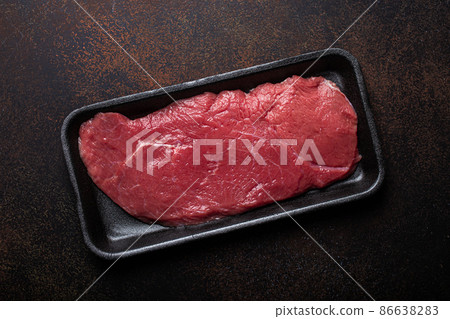 Beef lean raw fillet steak in black plastic container Beef lean raw fillet steak in black plastic container 86638283