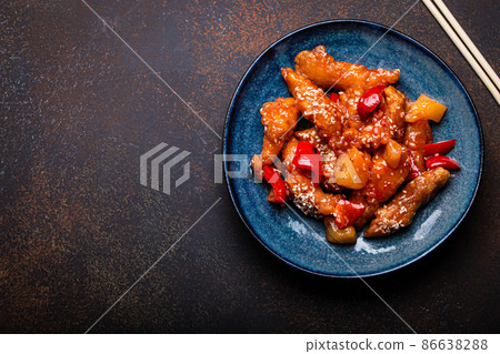 Chinese traditional wok dish sweet and sour deep fried chicken with vegetables stir-fry on plate Chinese traditional wok dish sweet and sour deep fried chicken with vegetables stir-fry on plate 86638288