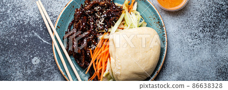 Chinese traditional dish sweet and sour deep fried glazed pork with vegetables and steamed bao bun 86638328
