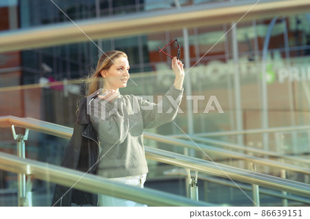 young blond slavic woman with long hair street portrait with glasses on shaping mall background young blond slavic woman with long hair street portrait with glasses on shaping mall background 86639151