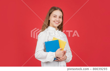 happy kid in white shirt ready to study do homework with book on red background, school happy kid in white shirt ready to study do homework with book on red background, school 86639293