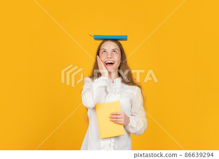 amazed kid with school homework on yellow background, knowleldge 86639294